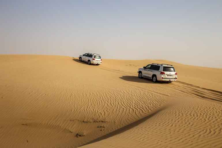 vehicles traveling in a desert