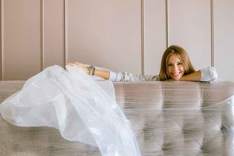 woman smiling behind the headboard